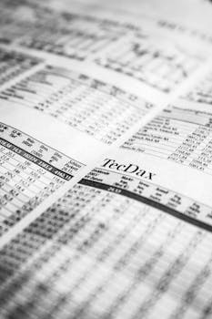 Close-up of a printed stock market report in black and white, highlighting stock prices.